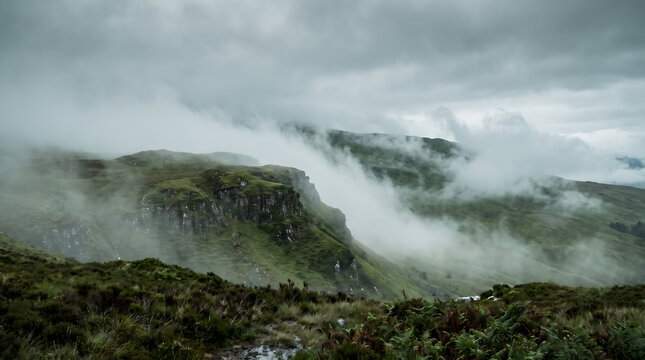 Misty and foggy green tropical mountain landscape with thick low hanging clouds