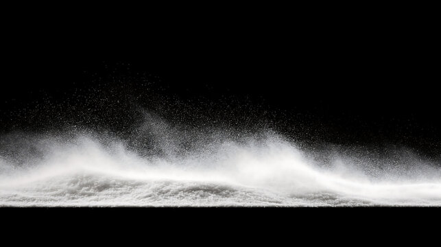Winter blizzard spray overlay. White snow powder explosion. White snow blowing in wind against black background. Snowdrift with swirling powder particles.  