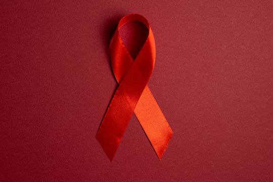 Red awareness ribbon symbolizing the fight against HIV and AIDS, solidarity with people living with HIV and remembrance