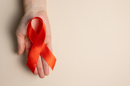 Red awareness ribbon symbolizing the fight against HIV and AIDS, solidarity with people living with HIV and remembrance
