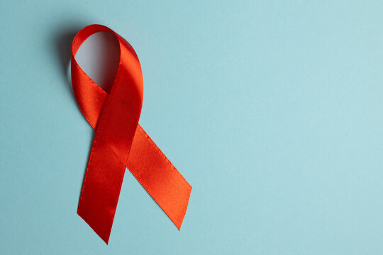 Red awareness ribbon symbolizing the fight against HIV and AIDS, solidarity with people living with HIV and remembrance