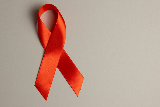 Red awareness ribbon symbolizing the fight against HIV and AIDS, solidarity with people living with HIV and remembrance