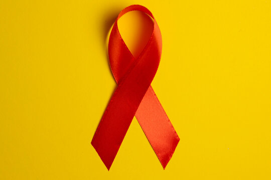 Red awareness ribbon symbolizing the fight against HIV and AIDS, solidarity with people living with HIV and remembrance