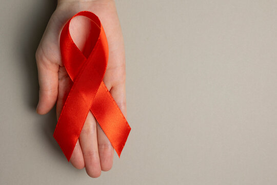 Red awareness ribbon symbolizing the fight against HIV and AIDS, solidarity with people living with HIV and remembrance