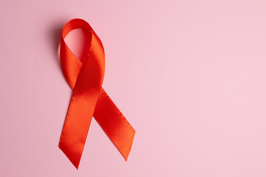 Red awareness ribbon symbolizing the fight against HIV and AIDS, solidarity with people living with HIV and remembrance