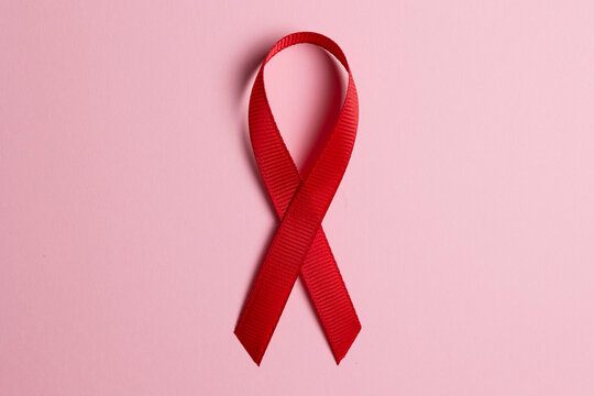 Red awareness ribbon symbolizing the fight against HIV and AIDS, solidarity with people living with HIV and remembrance