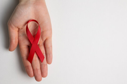 Red awareness ribbon symbolizing the fight against HIV and AIDS, solidarity with people living with HIV and remembrance