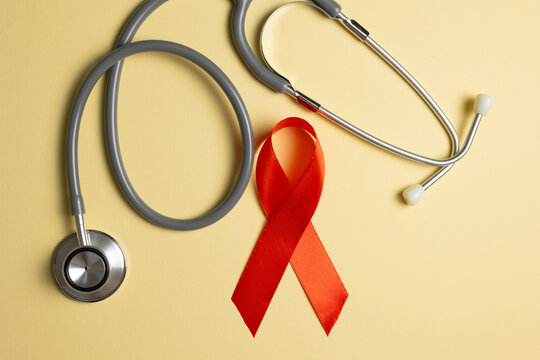Red awareness ribbon symbolizing the fight against HIV and AIDS, solidarity with people living with HIV and remembrance