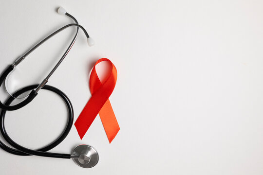 Red awareness ribbon symbolizing the fight against HIV and AIDS, solidarity with people living with HIV and remembrance