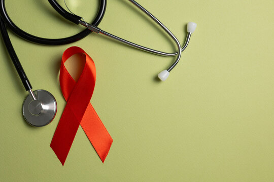 Red awareness ribbon symbolizing the fight against HIV and AIDS, solidarity with people living with HIV and remembrance