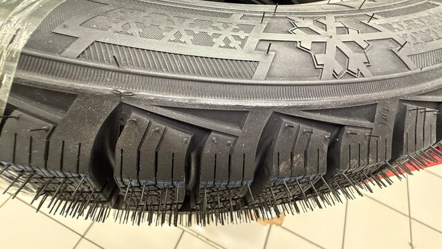 Close-up of textured car tire tread with intricate patterns for durability and performance