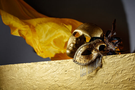 Golden carnival masks on a gold background.