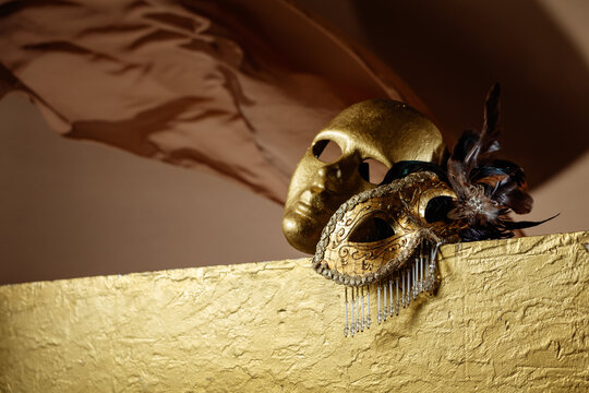 Golden carnival masks on a gold background.