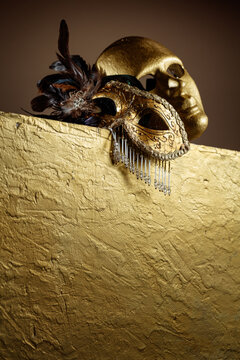 Golden carnival masks on a gold background.