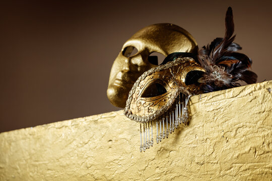 Golden carnival masks on a gold background.