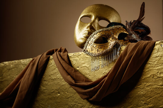 Golden carnival masks on a gold background.