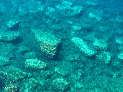 Blue azure sea with rocky seabed