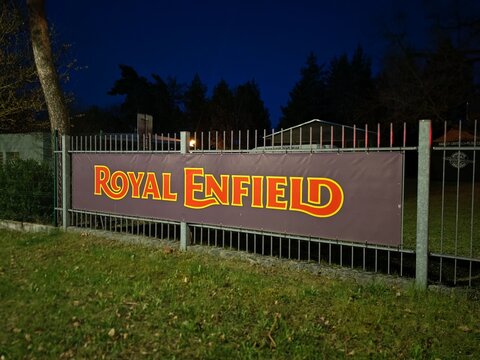 Plzen,Czech Republic-11 April 2026:Royal Enfield banner outside motorcycle dealership, daylight view