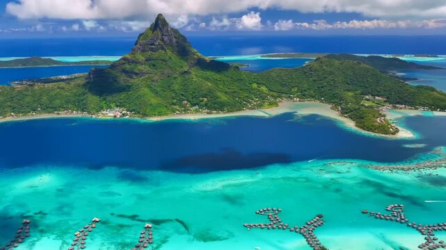 Video of French Polynesia tropical paradise 
island Bora Bora in Pacific Ocean. Beautiful clip with
sandy beach, palm trees, coral reef, azure ocean, sky 
with clouds on horizon. Drone aerial view.