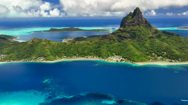 Video of French Polynesia tropical paradise 
island Bora Bora in Pacific Ocean. Beautiful clip with
sandy beach, palm trees, coral reef, azure ocean, sky 
with clouds on horizon. Drone aerial view.