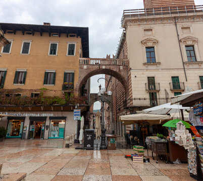 Arco della Costa archway between Palazzo della Ragione and Domus Nova in Piazza delle Erbe Verona Italy