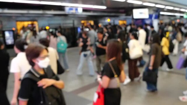 Slow motion Asian crowd at city train station 
