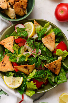 Traditional Lebanese vegetable salad Fattoush with crispy pita bread . top veiw .selective focus