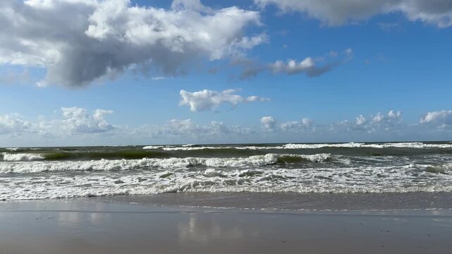 The Baltic Sea in summer, the shore and waves in beautiful, sunny weather.