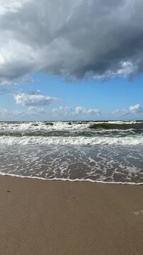 The Baltic Sea in summer, the shore and waves in beautiful, sunny weather.