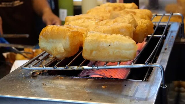 Grilling deep fried dough sticks 