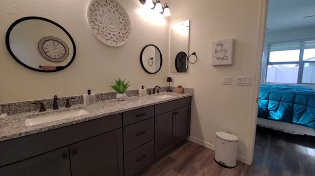 Bright doorway to sunlit bedroom from modern bathroom vanity