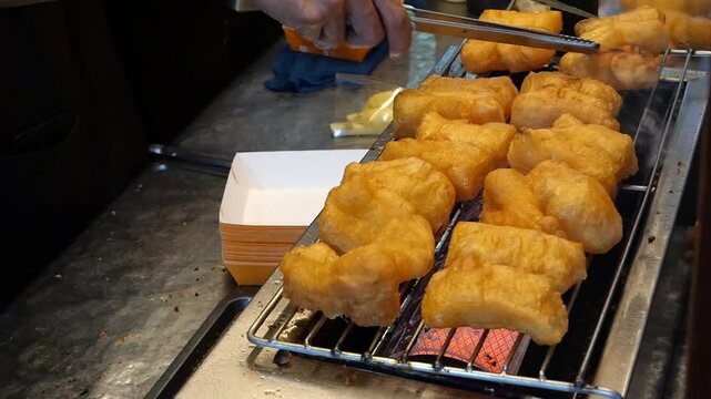 Grilling deep fried dough sticks 