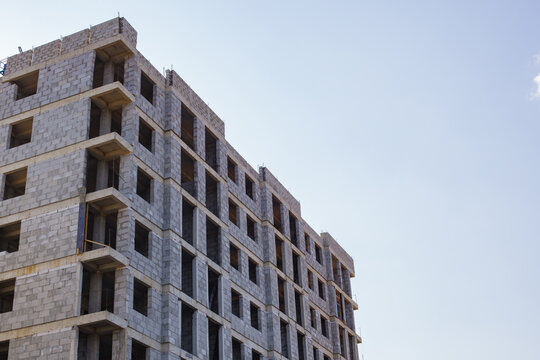 Modern unfinished residential concrete building construction with large copy space