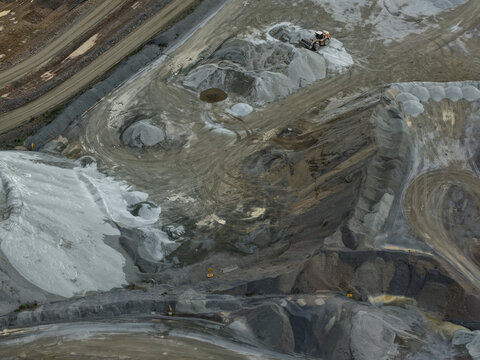 Montrose, Victoria, Australia - 26 August 2026: Aerial view of Boral Montrose quarry featuring large piles of gravel, heavy machinery, and earthmoving tracks on the ground.