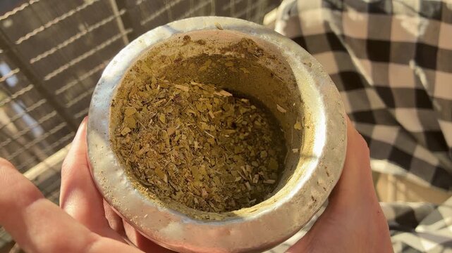 Close up of Traditional Yerba Mate Tea Infusion Warm Drink Lifestyle Scene on terrace, balcony, rooftop a Fall Day, Latin America. Typical social drink from Argentina, Uruguay, Paraguay and Brazil