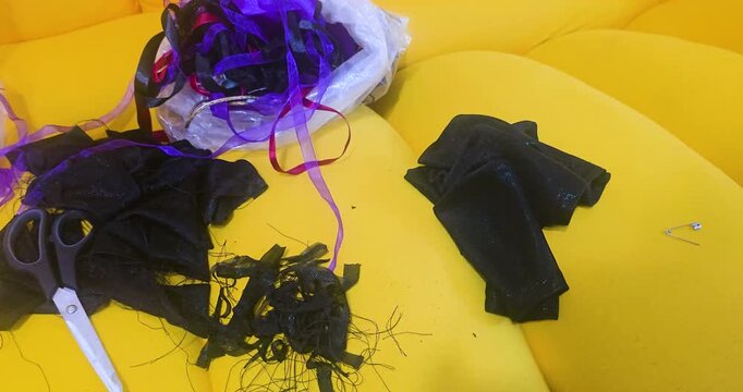Sewing kit: scissors, thread, and satin ribbons.