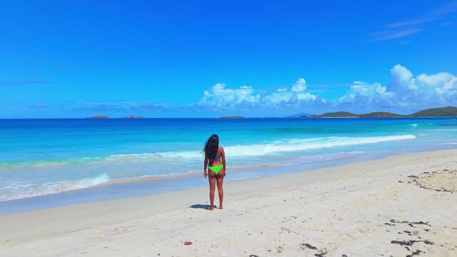 Aerial Drone View of an indian girl walking in bikini at the Calm Turquoise Waters at Zoni Beach, Culebra
