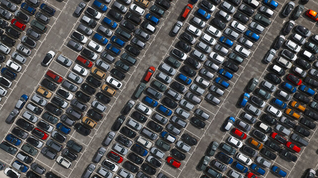 Spain - 22 August 2026: Aerial view of new cars parked on a parking lot waiting to be transported for export.