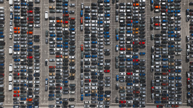 Spain - 22 August 2026: Aerial view of new cars parked in an organized lot waiting to be transported for export.