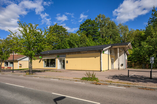 Skinnskatteberg, Sweden - August 18 2026: Small Swedish Systembolaget shop beside quiet tree lined street.
