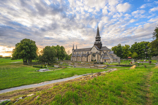 Varnhem, Sweden - August 18 2026: Expansive Varnhem Abbey Church landscape with cemetery and sunset sky.