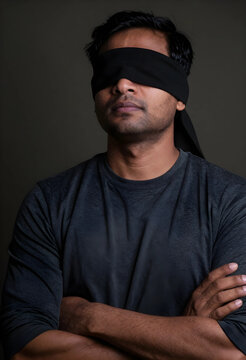 Blindfolded man with arms crossed of uncertainty ignorance risk and lack of vision or directionless