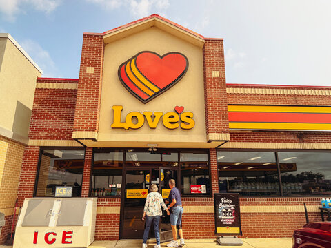 Ina, Illinois, USA - June 9, 2026: Exterior storefront of a Love's Travel Stop and Country Store as two people walk through the front entrance.