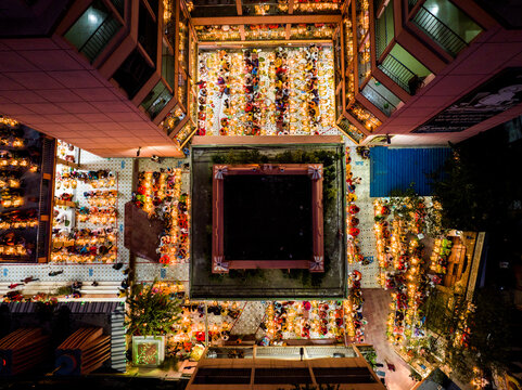 Dhaka, Bangladesh - 04 November 2023: Aerial view of Swamibagh Road temple courtyard filled with people celebrating with traditional lamps during a religious festival.