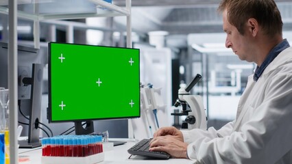 Desktop mockup sits beside a scientist analyzing experiment data in a chemistry lab for molecular...