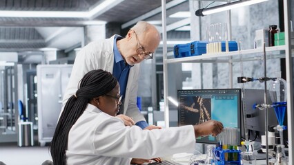 Woman scientist examines experiment data with a coworker in a laboratory, supporting healthcare...