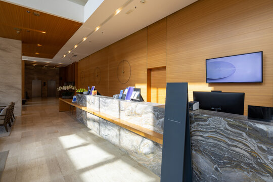 Luxury hotel reception desk made of dark marble in a modern spacious lobby area