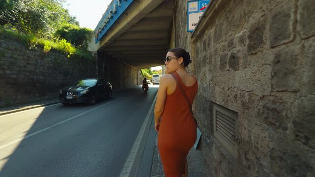Woman Walking and looking back on a Sunny Sorrento Street in Italy