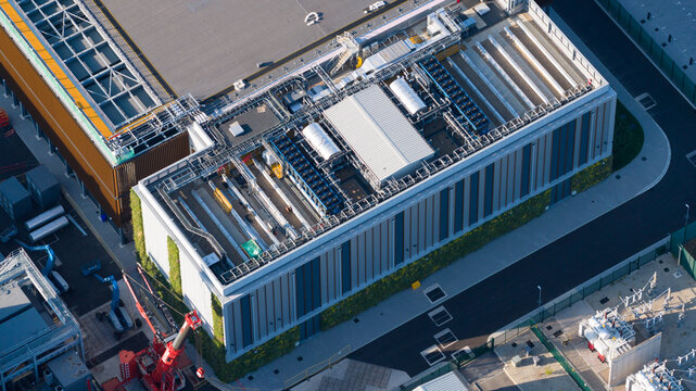 Longcross, United Kingdom - 31 July 2026: Aerial view of Netflix Studios Longcross featuring a modern industrial building with complex rooftop HVAC systems and vertical green walls.