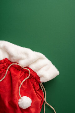 Merry Christmas red Santa sack with present for a happy New Year celebration on vertical green background